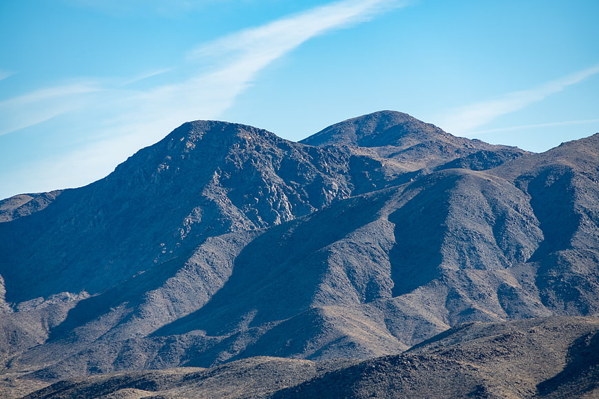 Rugged Desert Mountain Peaks Under Blue Sky