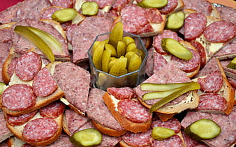 Appetizing platter of salami and liverwurst sandwiches with pickles