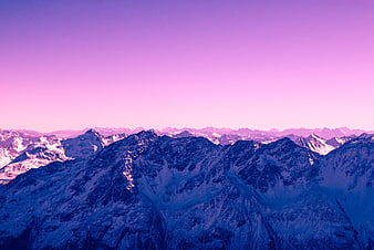 Snowy Mountain Range Under Vibrant Purple Sky