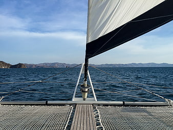 View from catamaran bow sailing on blue ocean