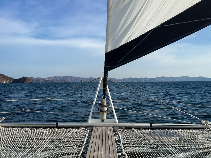 View from catamaran bow sailing on blue ocean