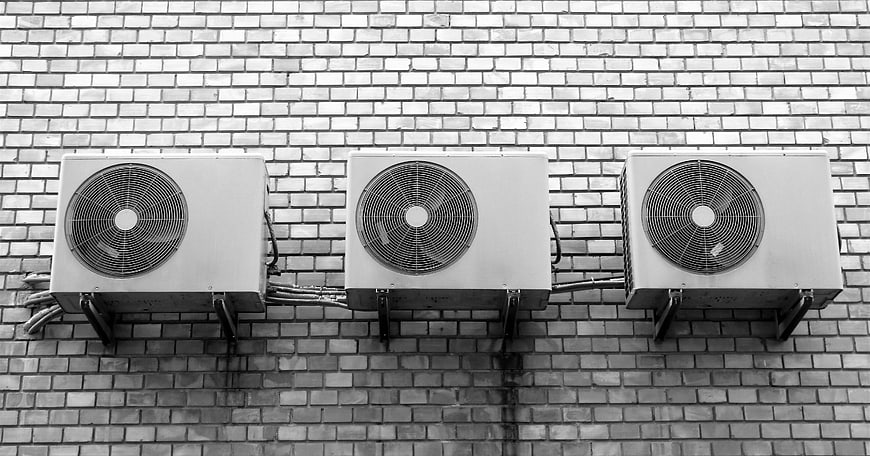 Three Air Conditioners on Brick Wall Black and White