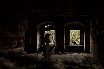 Dark hooded figure in abandoned ruin with fog and crow