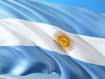 Waving Flag of Argentina Against Blue Sky