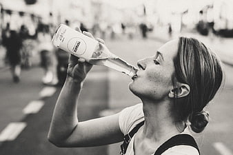 Woman Drinking Water from Bottle Outdoors