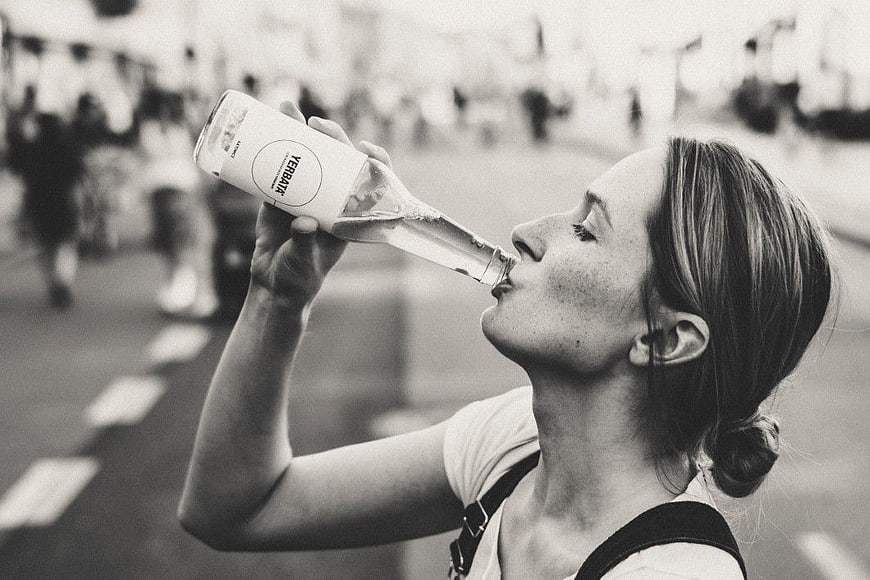 Woman Drinking Water from Bottle Outdoors