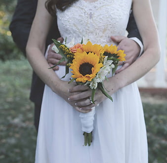 Bride and Groom Holding Sunflower Wedding Bouquet