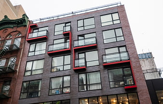 Modern Brick Apartment Building with Red Balconies