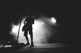 Silhouette of Rock Guitarist Performing on Smoky Stage