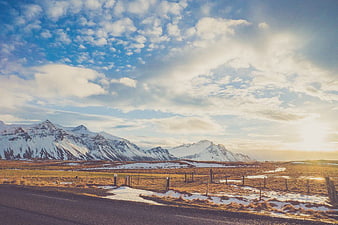 Snow-Capped Mountains and Golden Grassland Landscape