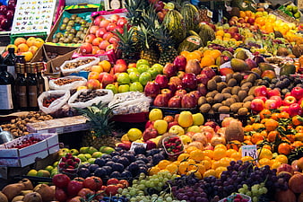 Vibrant Moroccan Market Stall Displaying Fresh Fruits And Wine