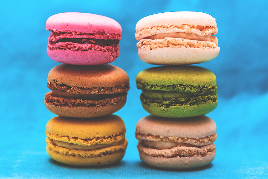 Colorful Stacked Macarons on Blue Background