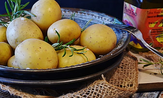 Fresh boiled yellow potatoes with rosemary and salt in a bowl