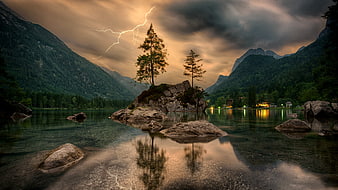Dramatic Lightning Storm Over Alpine Lake with Reflections