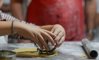Child Hands Cutting Cookie Dough with Metal Cutter