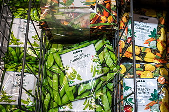 Frozen vegetables in supermarket wire basket display