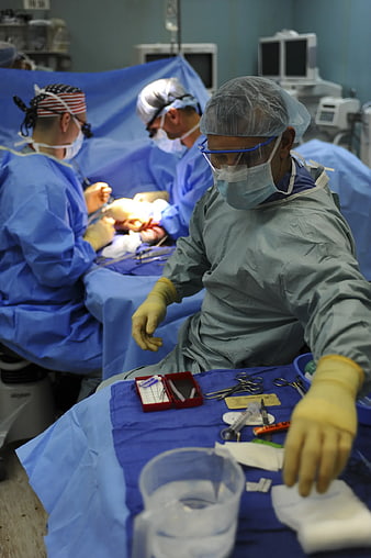 Surgeons performing surgery in operating room