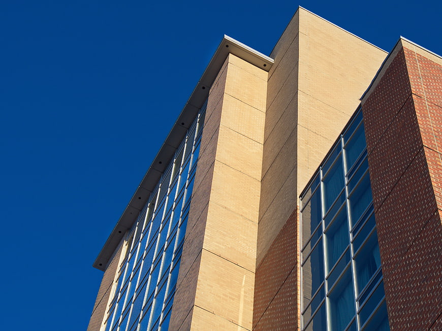 Modern Brick and Glass Building Facade Against Blue Sky