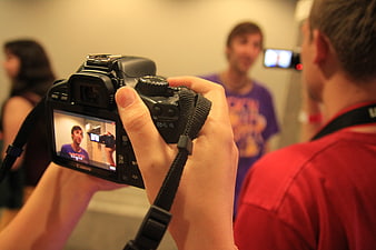 Close-up of DSLR Camera Recording Video of People