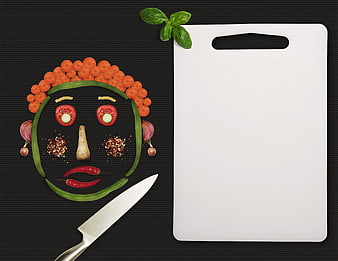 Creative vegetable face art with cutting board and knife