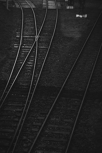 Black and white railroad tracks with switch and gravel