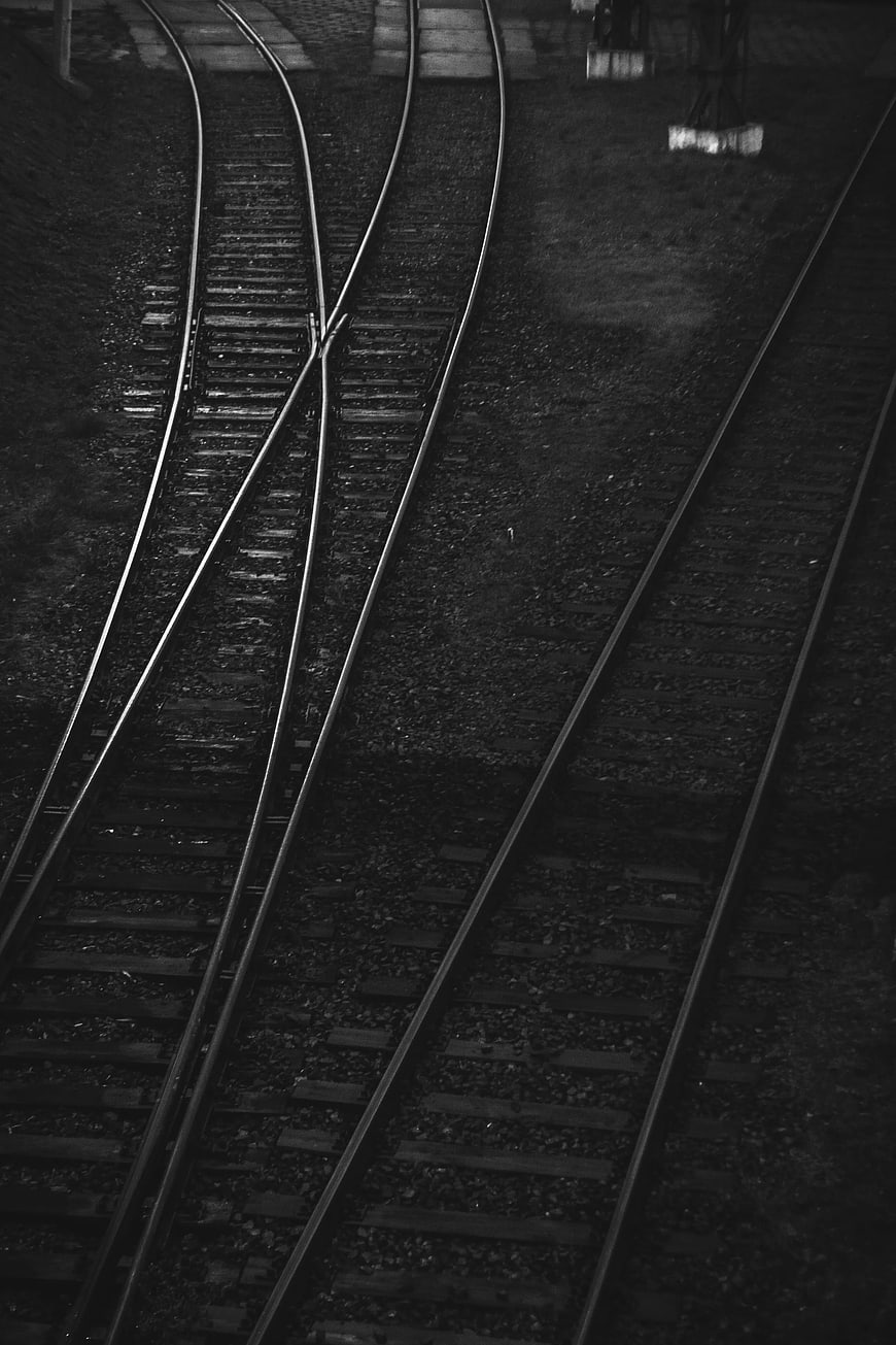 Black and white railroad tracks with switch and gravel