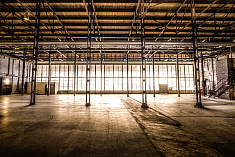 Vast Abandoned Industrial Factory Interior With Steel Beams And Concrete Floor