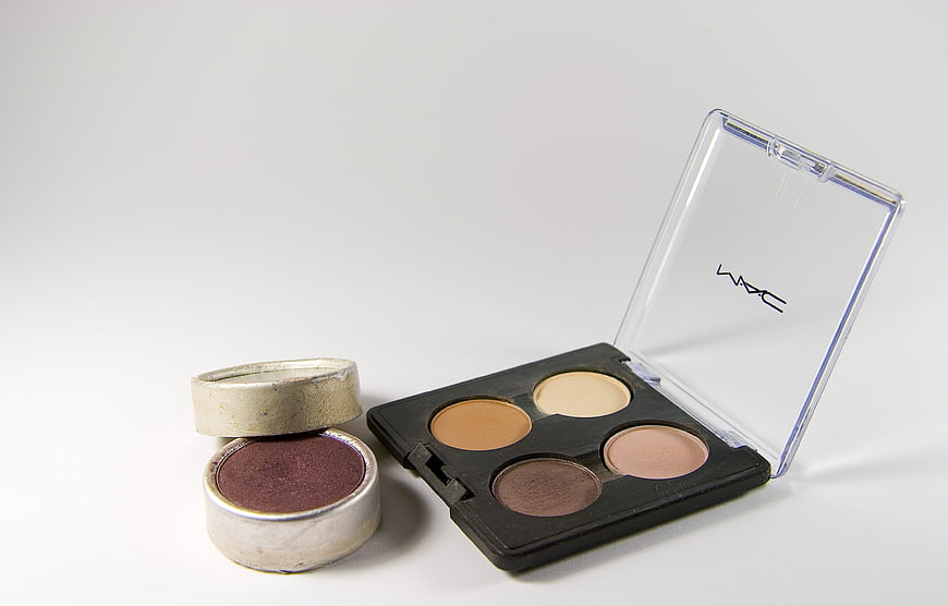 MAC Eyeshadow Palette And Loose Powder On White Background