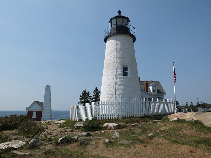 White Lighthouse on Rocky Coast with Ocean View