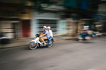 Couple Riding Motorcycle on Blurred City Street