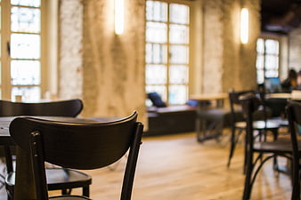 Blurred Interior of a Modern Cafe with Wooden Chairs