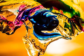 Abstract colorful liquid splash with bubbles on yellow background