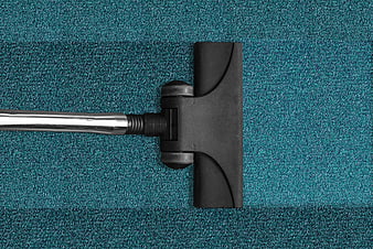Top View of Vacuum Cleaner Head Cleaning Blue Carpet
