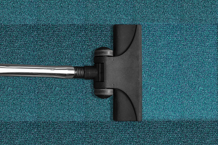 Top View of Vacuum Cleaner Head Cleaning Blue Carpet