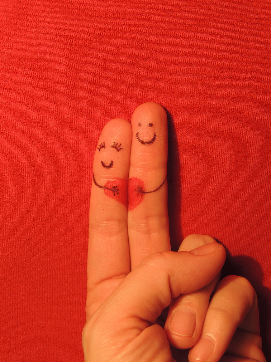 Creative Finger Couple Holding Hands on Red Background