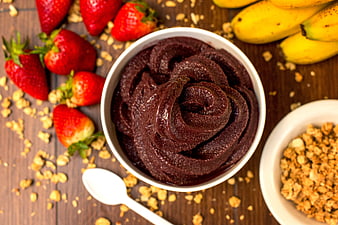Overhead view of acai bowl with strawberries and granola