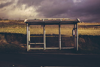 Empty rural bus shelter under dramatic cloudy sky