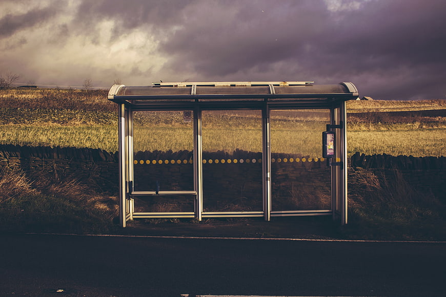 Empty rural bus shelter under dramatic cloudy sky