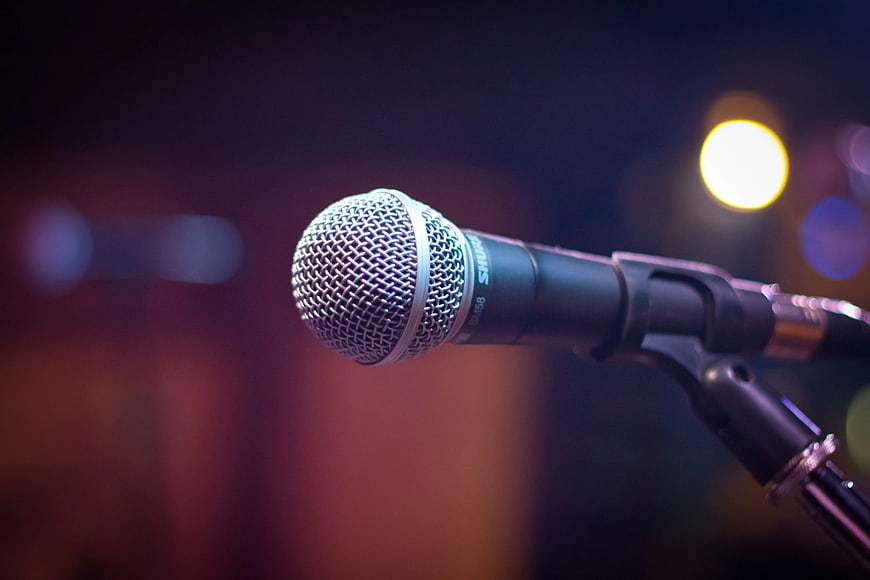 Close-up of Microphone on Stage with Bokeh Lights