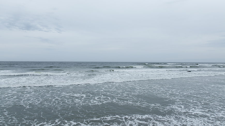 Gray ocean waves rolling on a cloudy overcast day