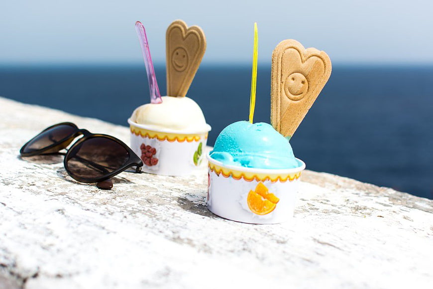 Two Cups of Ice Cream with Wafers and Sunglasses by the Sea