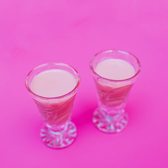 Two Pink Cocktail Shots on Vibrant Pink Background