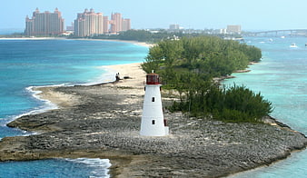 White Lighthouse on Rocky Island with Atlantis Resort Background
