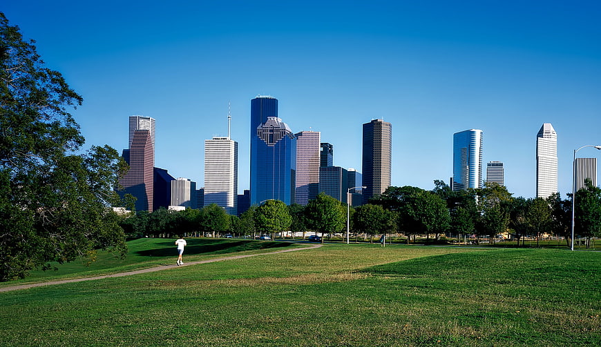 Houston Texas Skyline Viewed From A Green Urban Park With Jogger