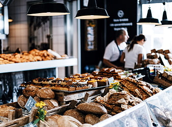 Artisanal Bread and Pastries Display in Modern Bakery Shop