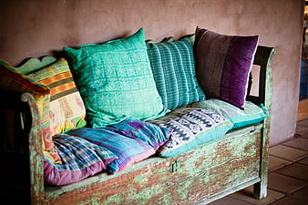 Rustic wooden bench with colorful patterned cushions