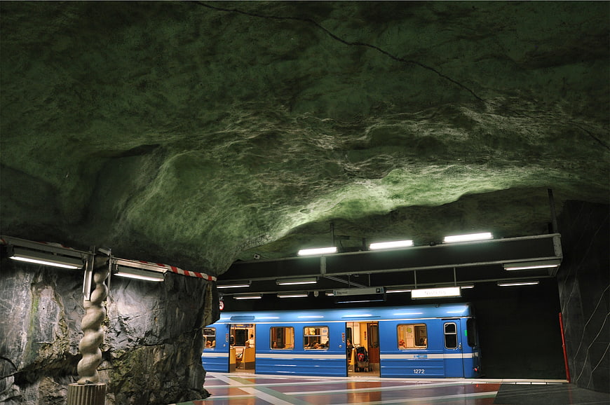 Blue subway train at Stockholm underground rock station