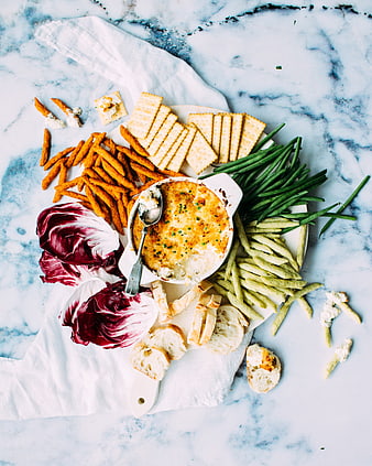 Overhead view of cheese dip platter with crackers and vegetables