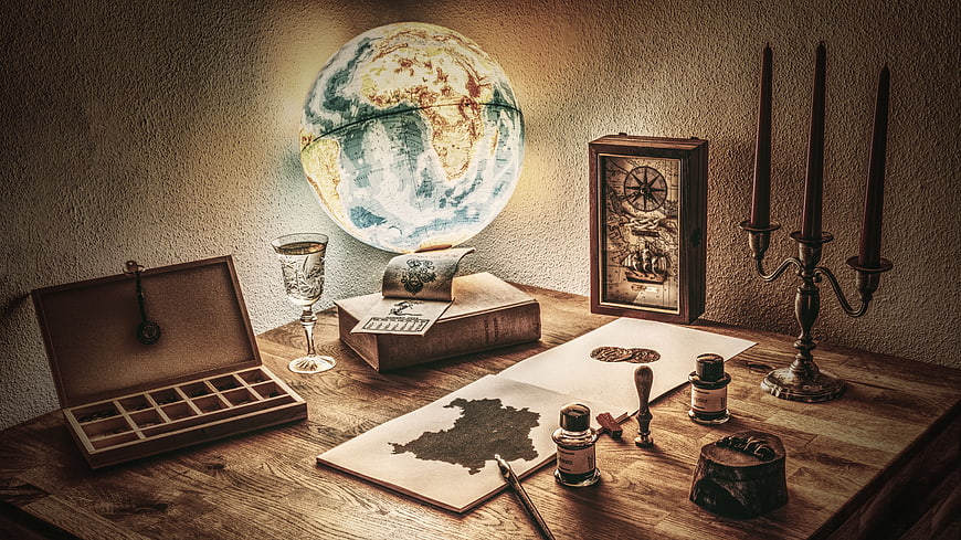 Vintage explorer desk with glowing globe and antique map