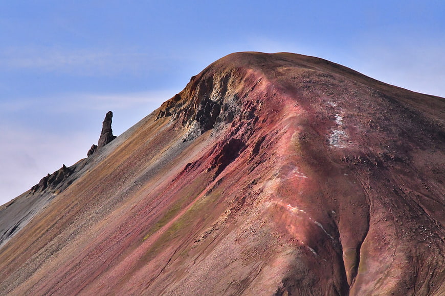 Colorful volcanic mountain slope with red and brown earth textures
